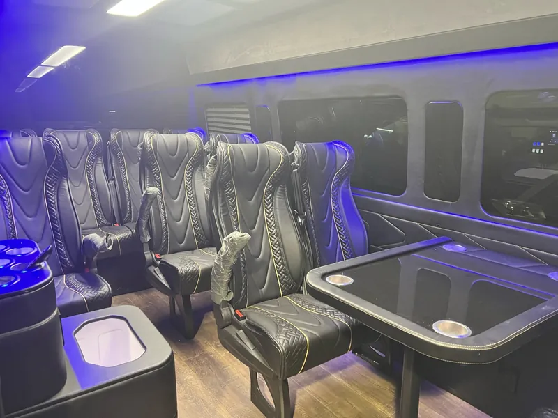 Executive Sprinter interior with leather seating and ambient lighting
